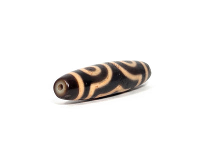 At-090326-3E4 antique three eye dzi warm reddish-brown agate angled opposite drill end two eyes visible, unretouched