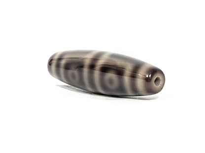N-071126-4EV end view one, four concentric ring eye motifs in row revealed from end angle, drill hole at tip, unretouched