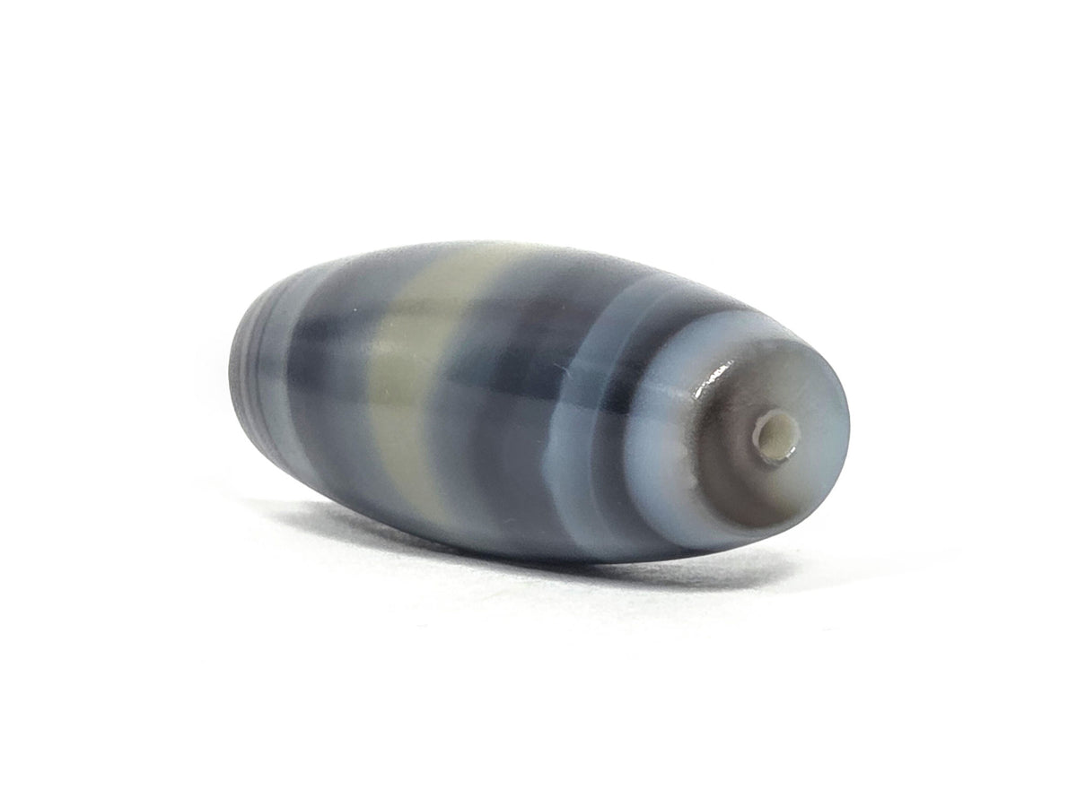 N-N-071426-1E4 end angle B — concentric micro-banding at drill end, darker cap, 50.3×20.5mm agate, unretouched.