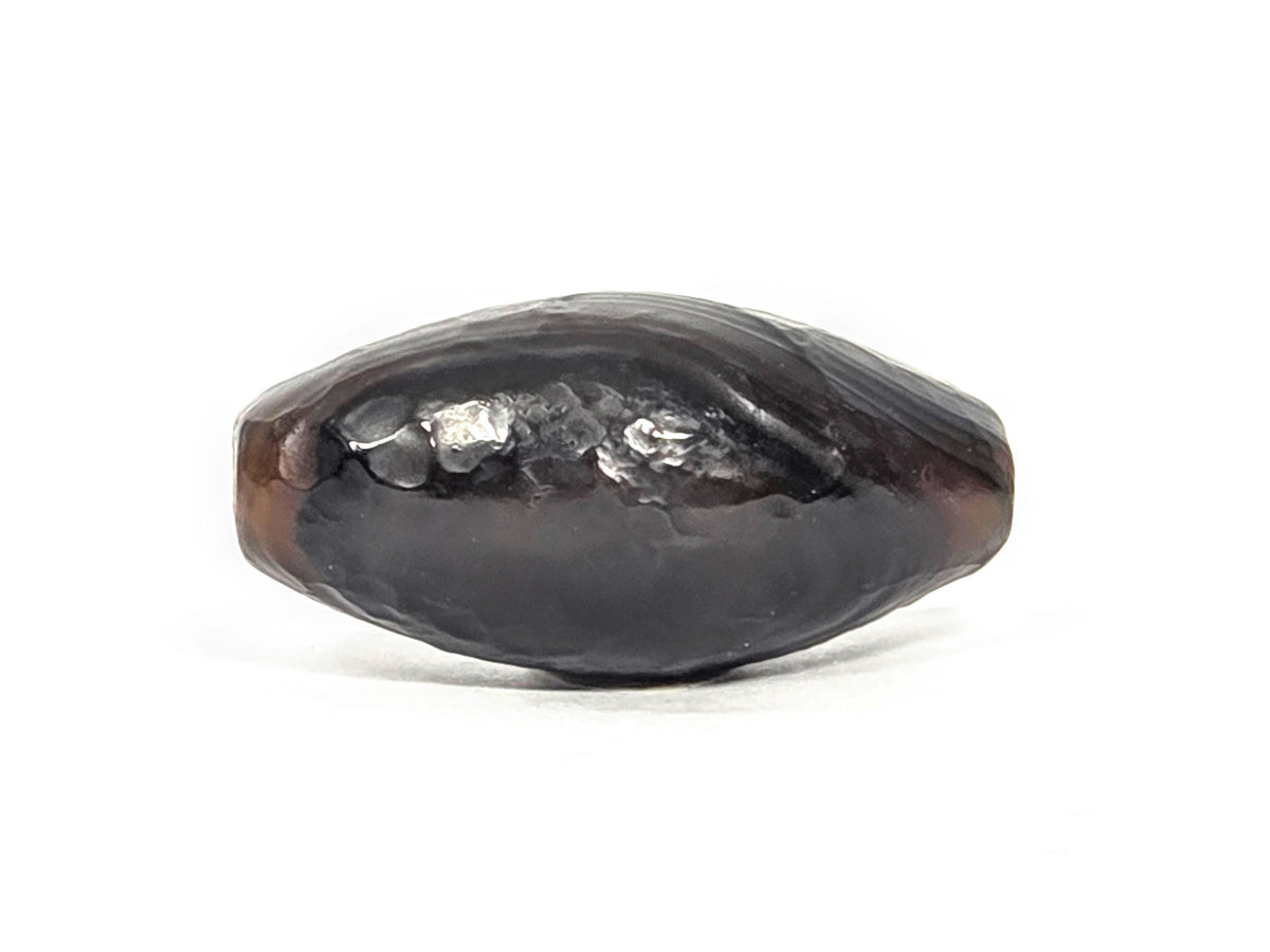N-N-071026-1E-OLV natural one eye dzi very dark brown agate face C dark ground rough perimeter unretouched