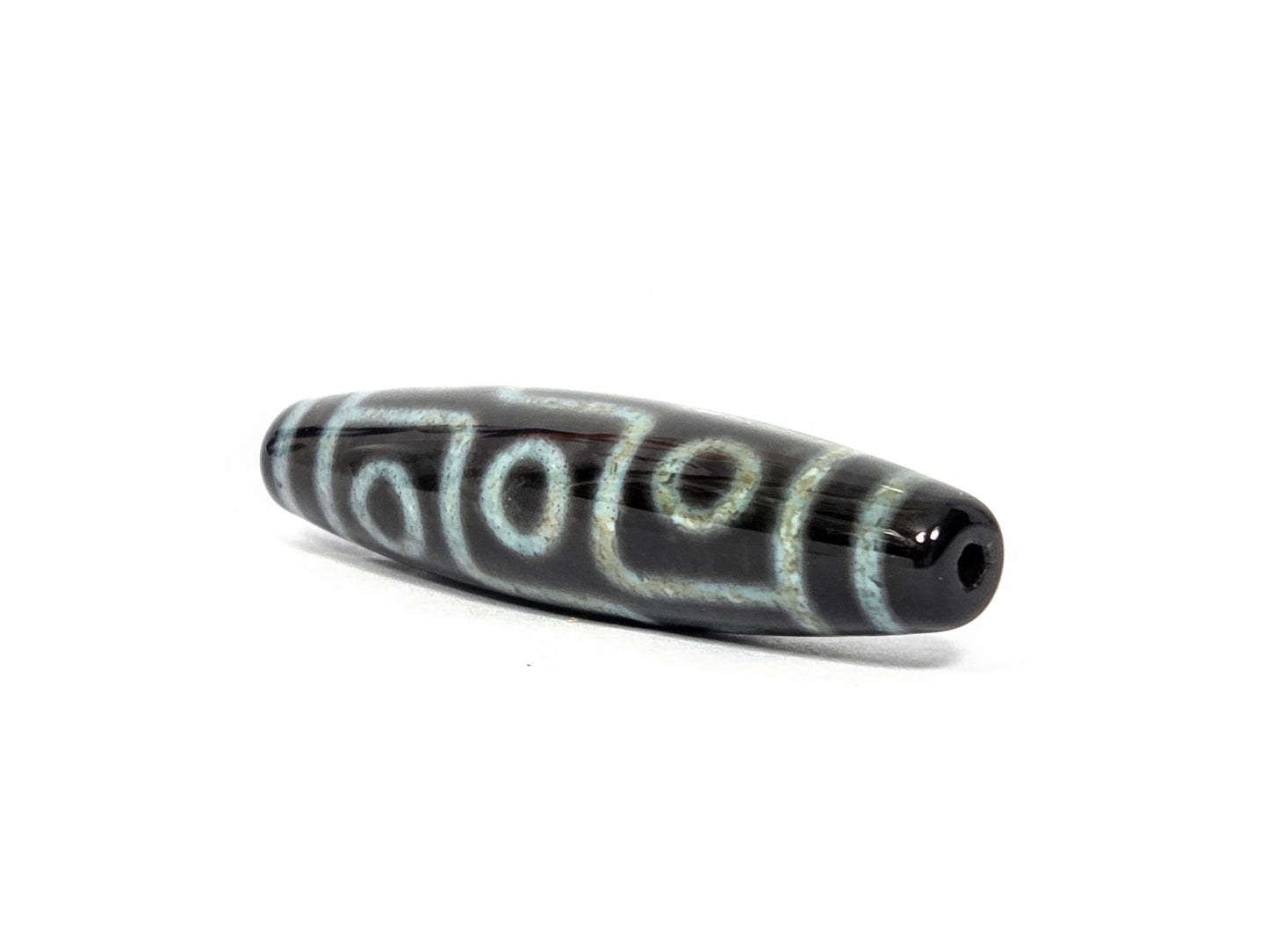 N-082326-9EBS2 new nine eye dzi bead drill end view one pitch-black tip fusiform barrel unretouched