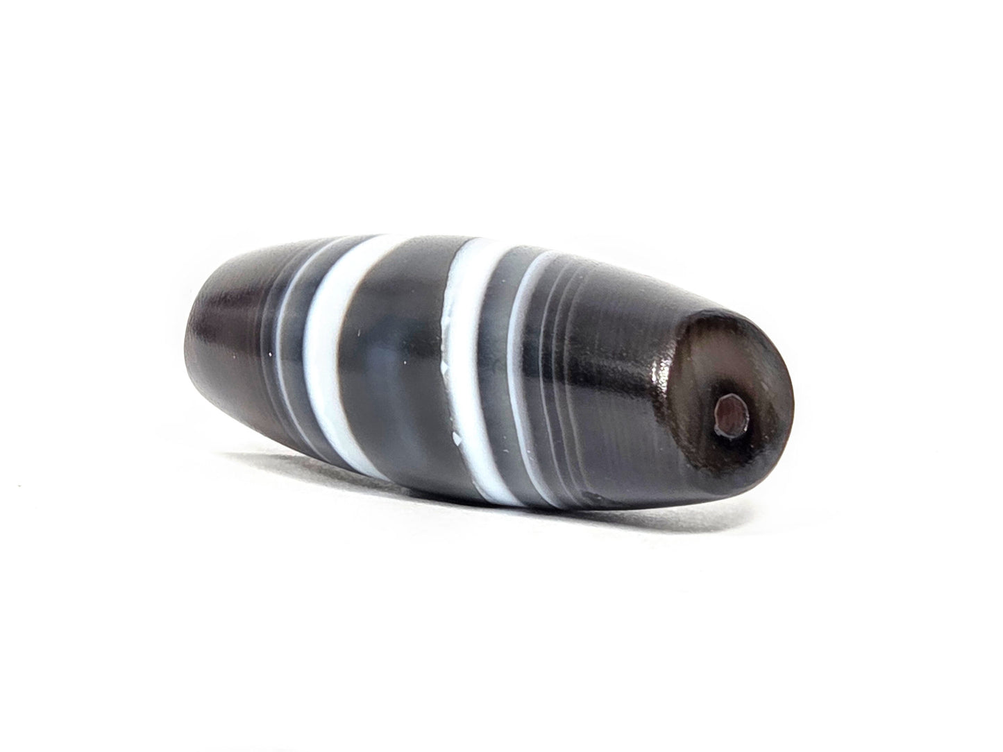 N-N-071026-1E3 natural one eye dzi angled view drill end A warm dark brown end cap small hole unretouched