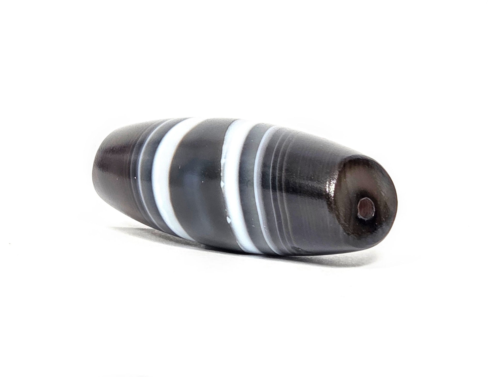 N-N-071026-1E3 natural one eye dzi angled view drill end A warm dark brown end cap small hole unretouched