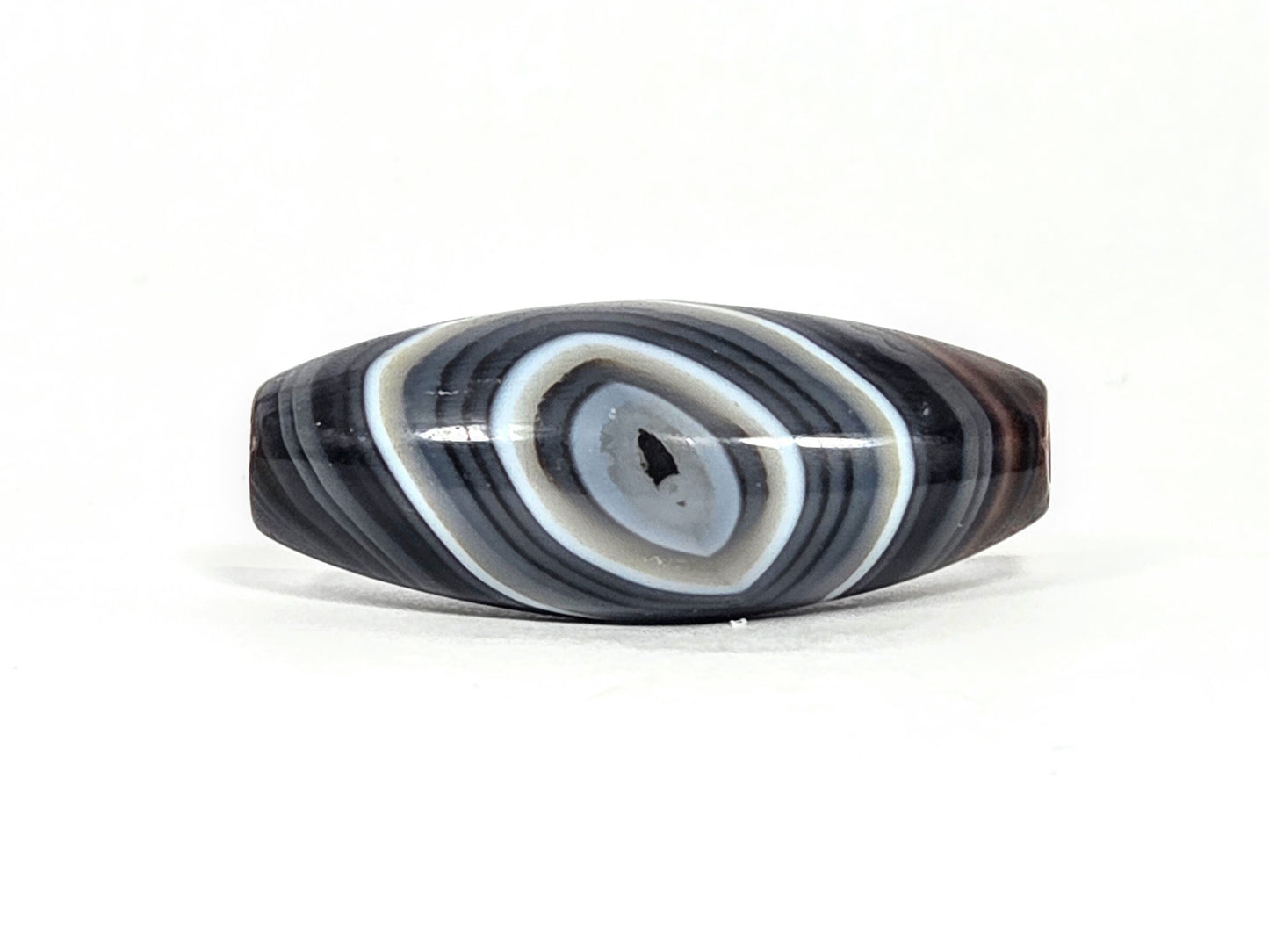 N-N-071026-1E-OLV2 front eye face, naturally formed one eye olive-form dzi, 39.1×15.8mm dark grey-brown banded agate, unretouched