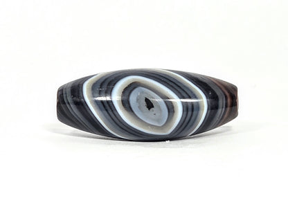 N-N-071026-1E-OLV2 front eye face, naturally formed one eye olive-form dzi, 39.1×15.8mm dark grey-brown banded agate, unretouched
