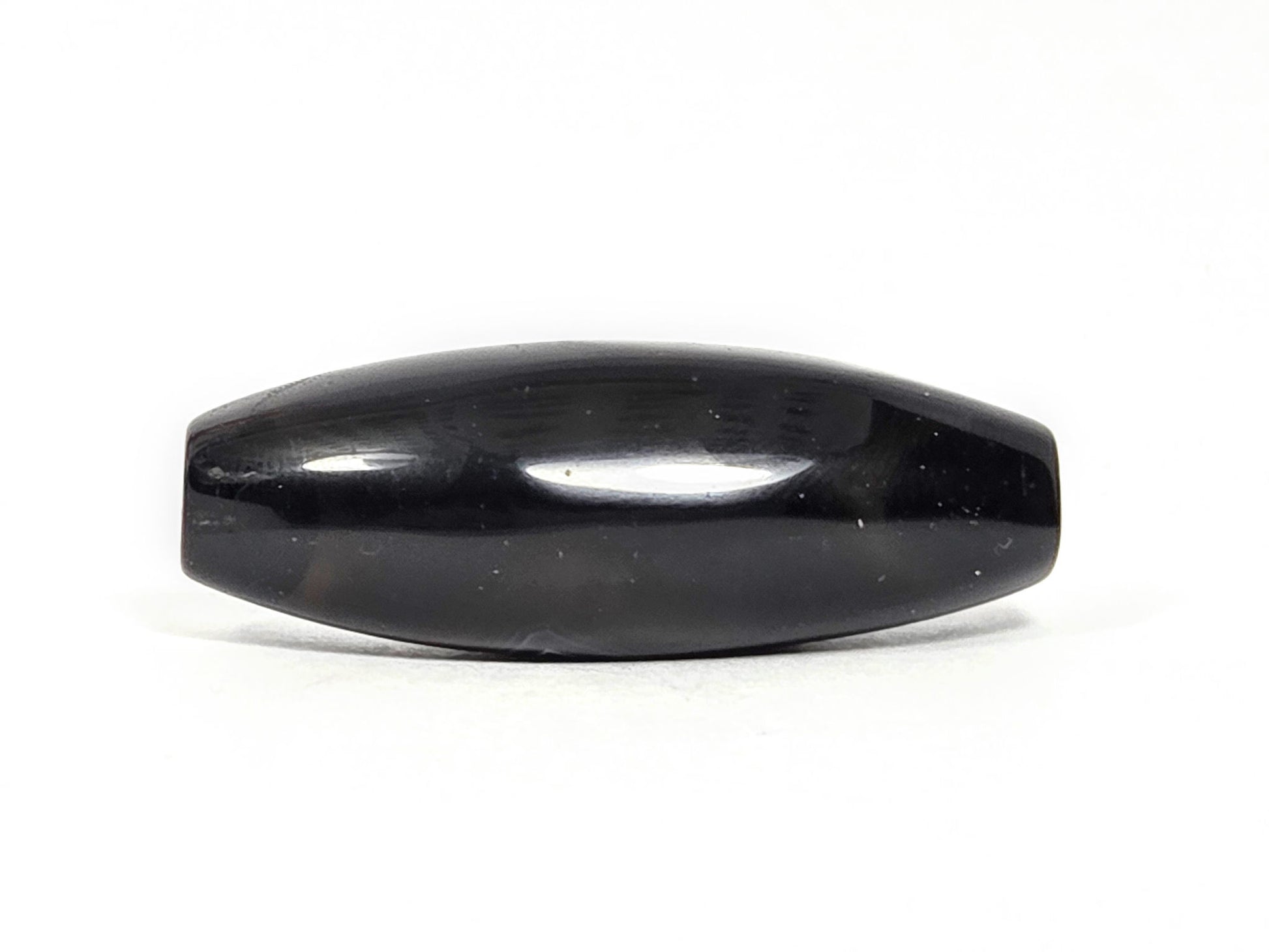 N-N-071126-1E-OLV3 back face, near-pitch-black ground, two faint surface marks disclosed, high gloss, unretouched