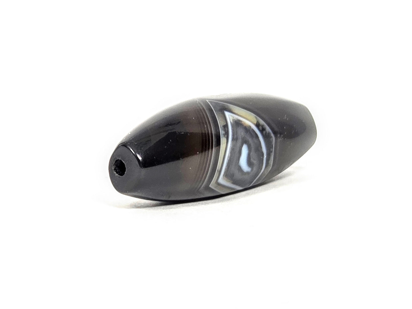 N-N-071126-1E-OLV3 three-quarter, wider rounded drill-hole end, blue-grey diamond banding zone prominent, unretouched