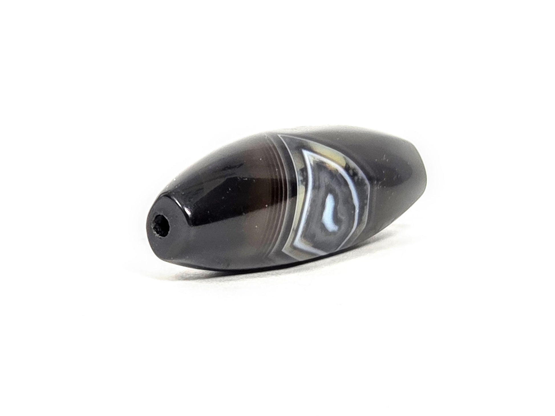 N-N-071126-1E-OLV3 three-quarter, wider rounded drill-hole end, blue-grey diamond banding zone prominent, unretouched