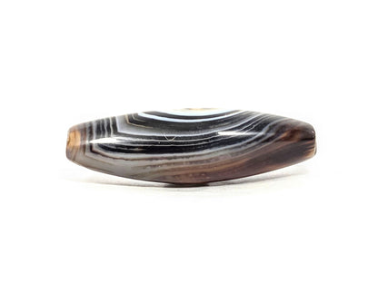 N-N-071126-1E-FCT upper side face, flat faceted surface, dense brown-black and grey-brown banding, warm honey-brown end, unretouched