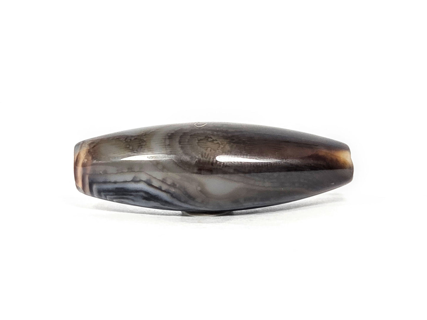 N-N-071126-1E-FCT back face, warm brown-caramel banding, no eye, fine surface micro-texture at centre disclosed, unretouched