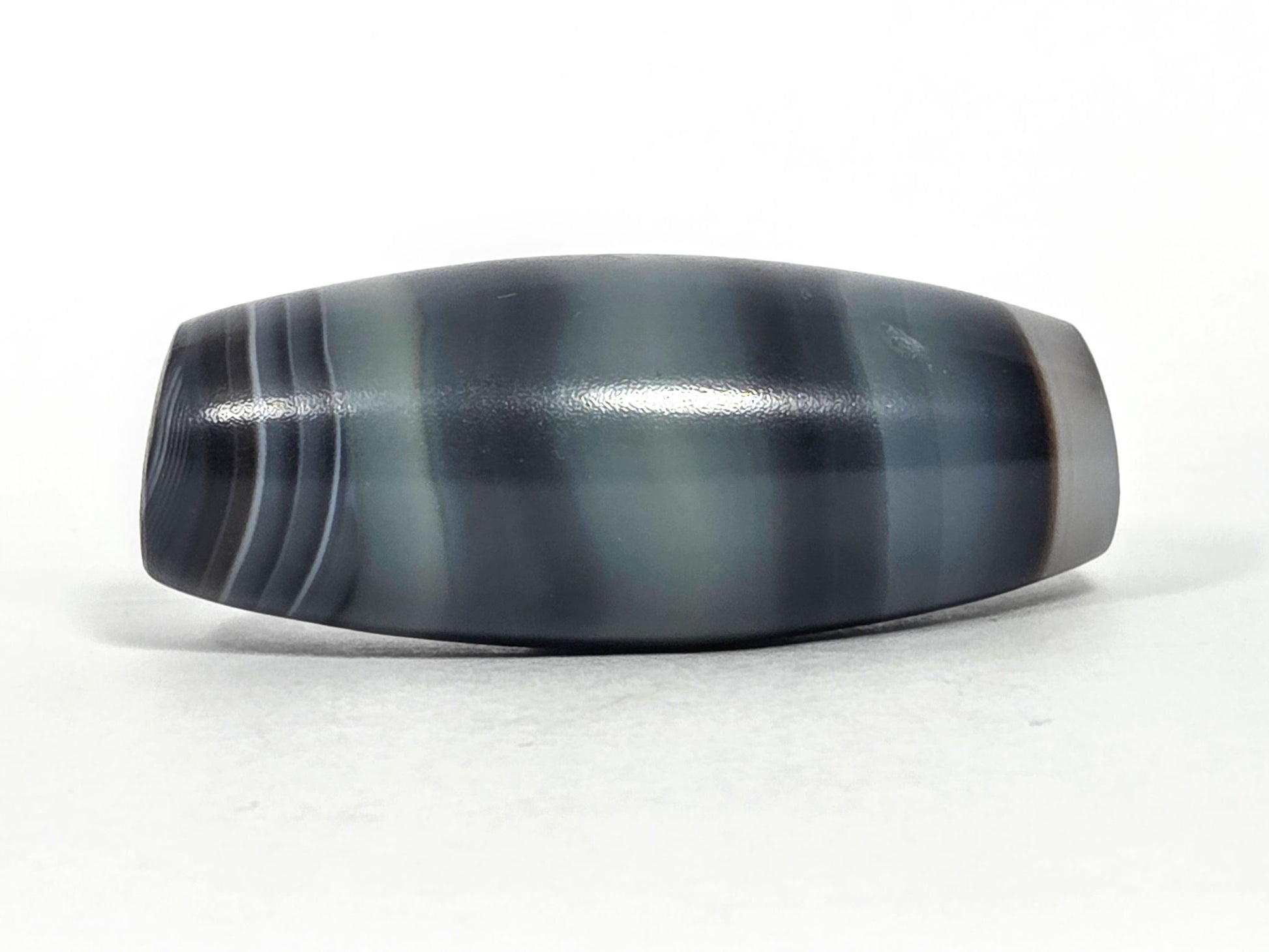 N-N-071426-1E4 natural one eye face C — steel-blue banding dominant, pale olive zone, high-gloss surface, unretouched. 