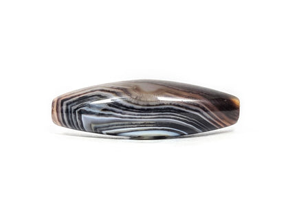 N-N-071126-1E-FCT lower side face, faceted form, blue-grey and brown banding, partial eye arc at right, unretouched