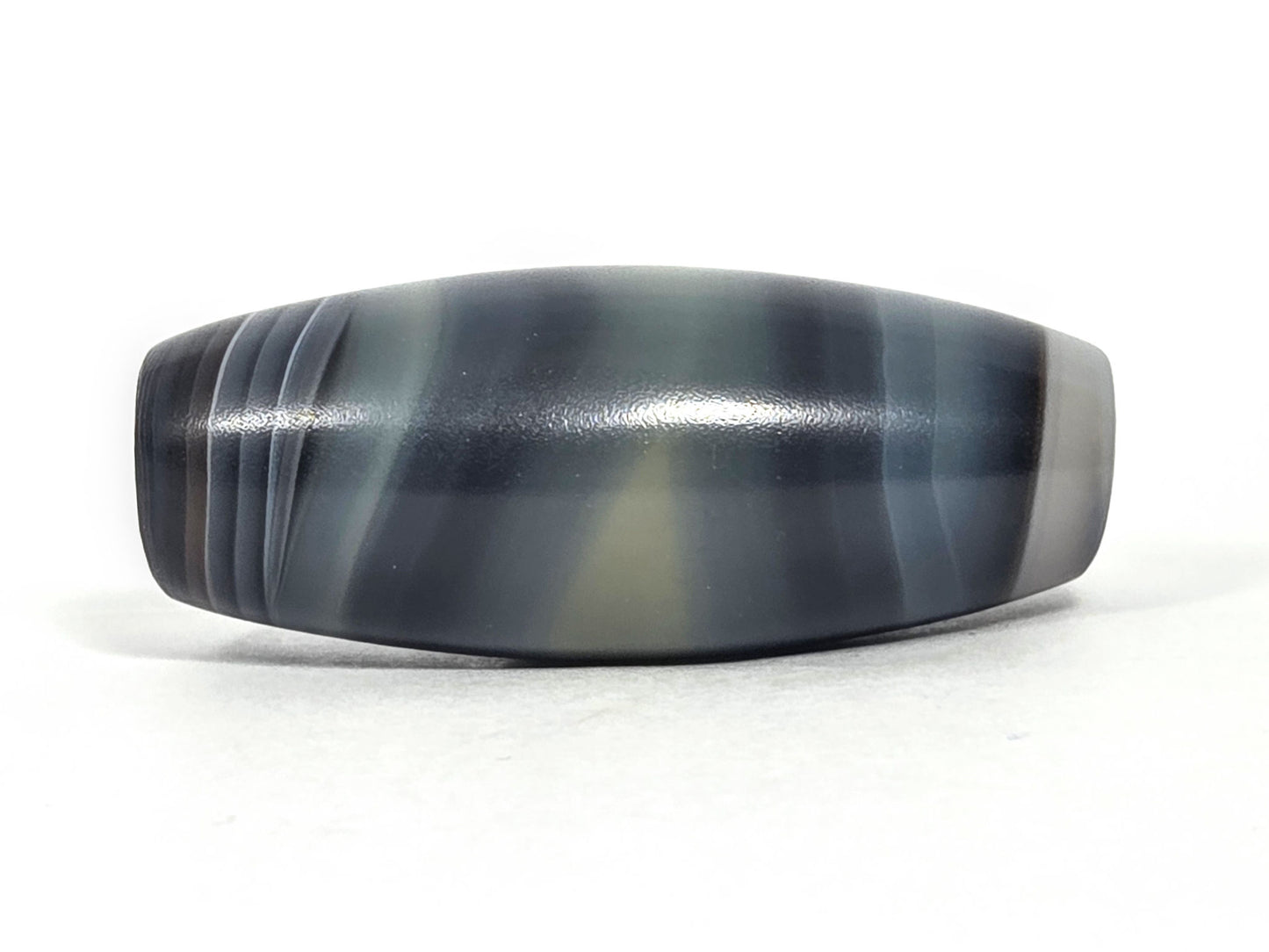 N-N-071426-1E4 natural one eye face D — banding composition shift, charcoal lines, olive-grey pale zone, unretouched.