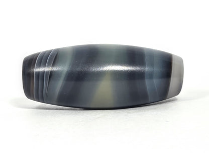 N-N-071426-1E4 natural one eye face D — banding composition shift, charcoal lines, olive-grey pale zone, unretouched.