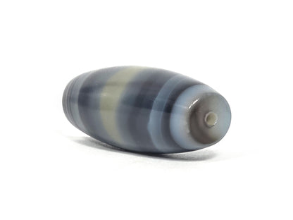 N-N-071426-1E4 end angle A — warm grey-brown end cap, small clean drill opening, banding wrap visible, unretouched.