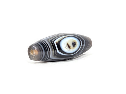 N-N-071126-1E-FCT three-quarter opposite end, second drill hole, honey-brown inclusion, bold blue-grey eye motif, unretouched