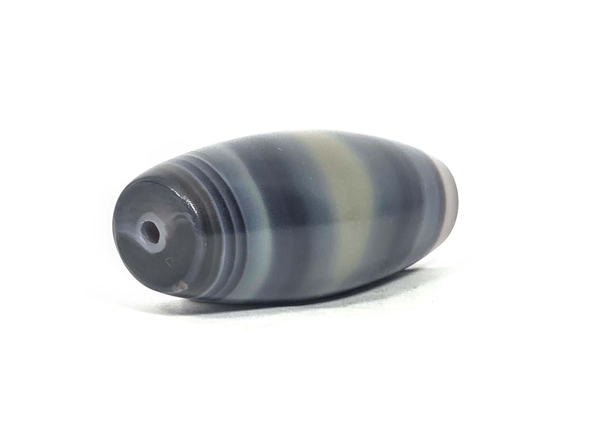 N-N-071426-1E4 end angle B — concentric micro-banding at drill end, darker cap, 50.3×20.5mm agate, unretouched.