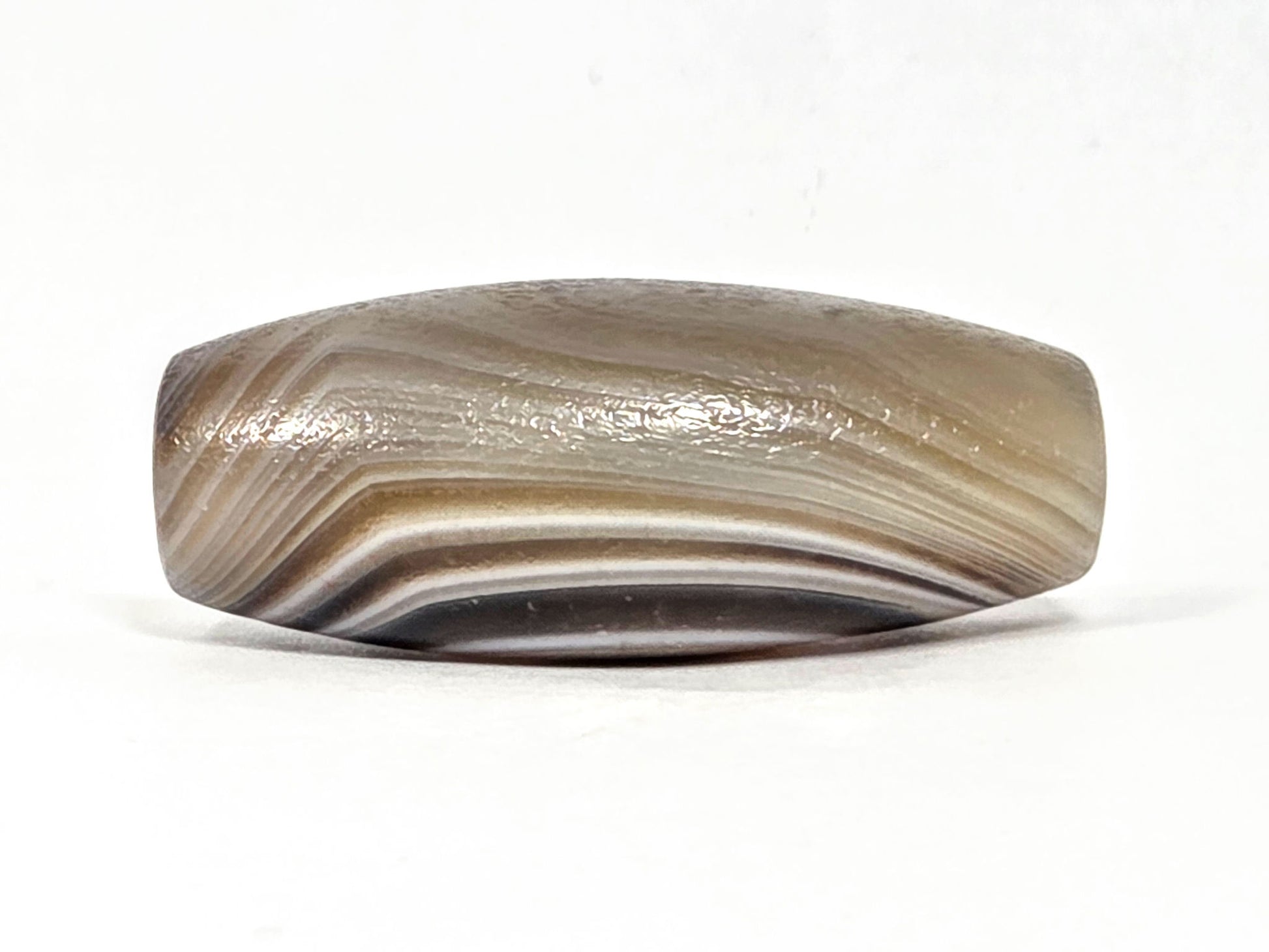 N-N-062126-1E2 dzi bead, angled side view, full band sweep visible, unretouched
