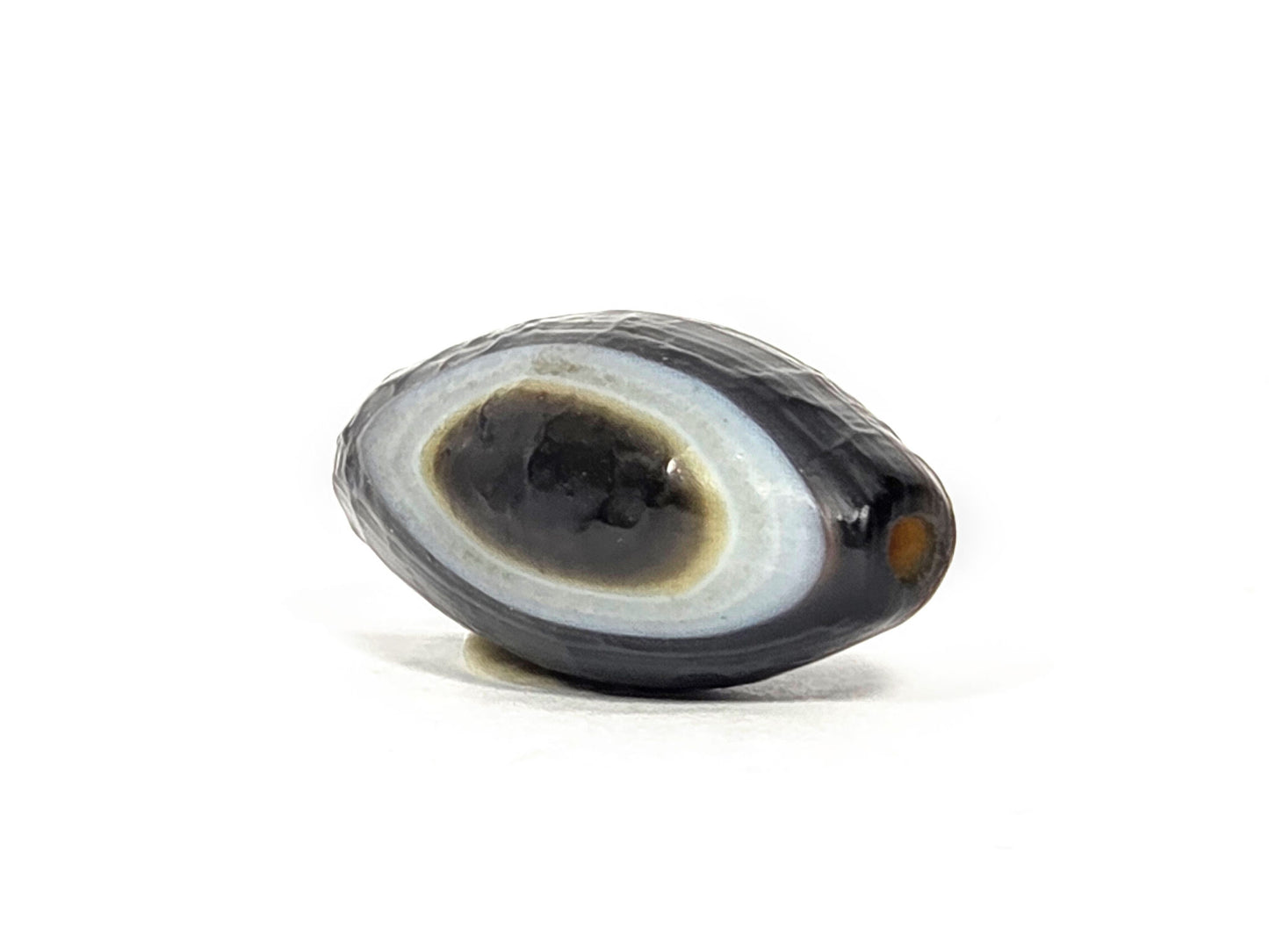 N-N-071026-1E-OLV natural one eye dzi angled view pointed drill end A eye face visible orange hole unretouched