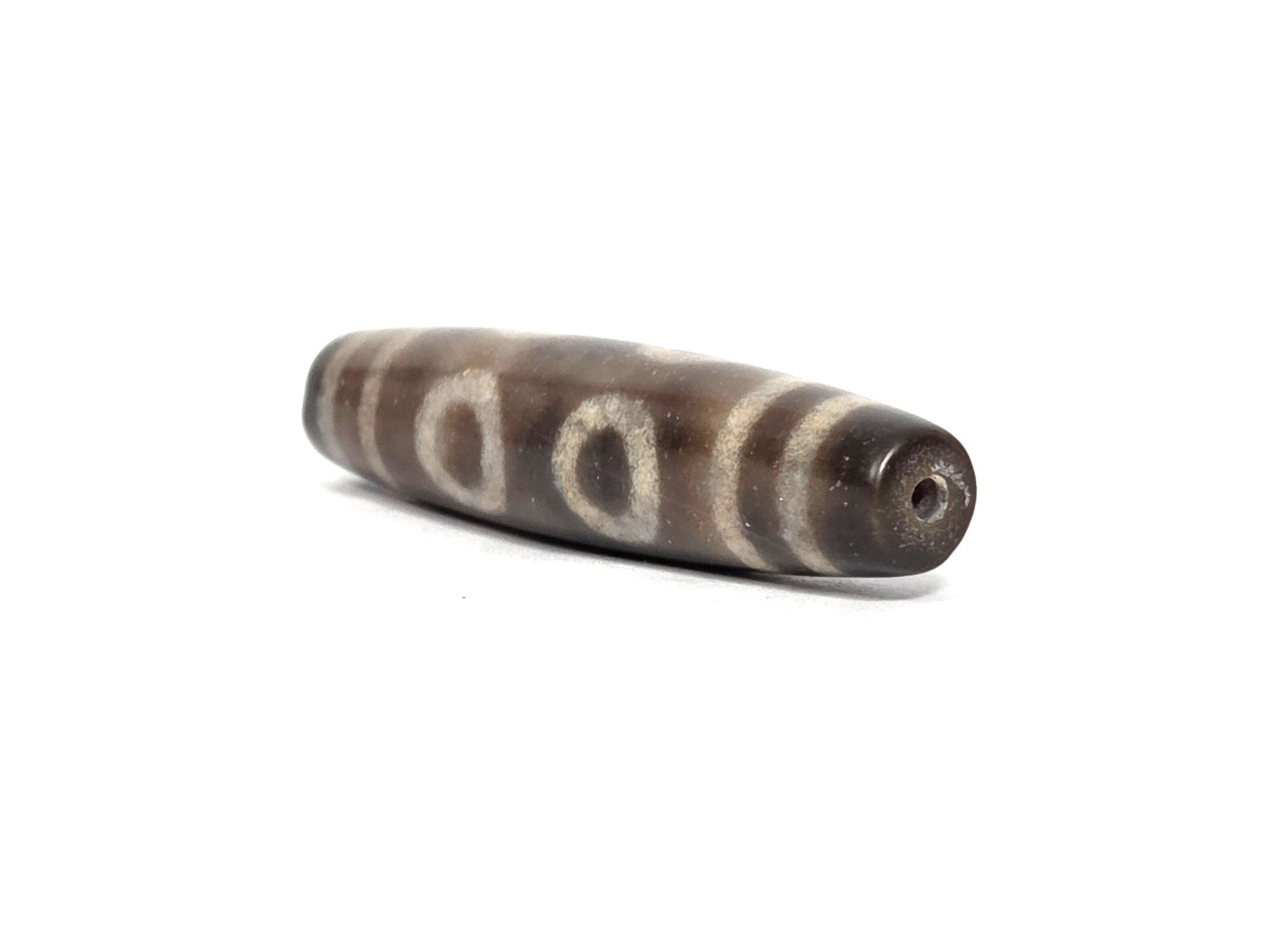 N-090326-6E new six eye dzi brown-grey agate angled drill end minor surface texture disclosed, unretouched