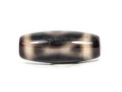 Two Eye motif N-FA-071426-2E face D — side profile, pitch-black body, cream band reads as stripe, unretouched. 