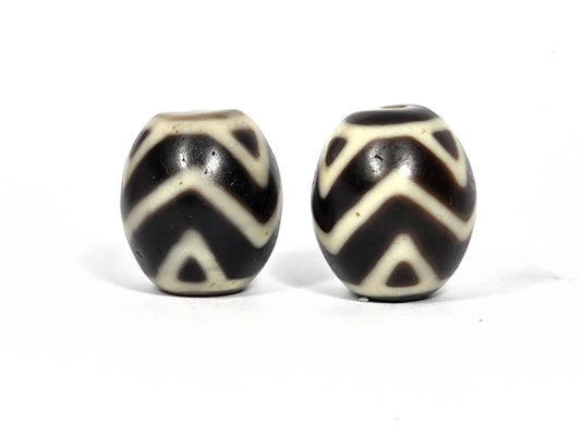 At-070626-TTW antique round Wave Tiger Tooth dzi bead pair, front view showing bold cream chevron wave lines on very dark brown ground, both beads, unretouched