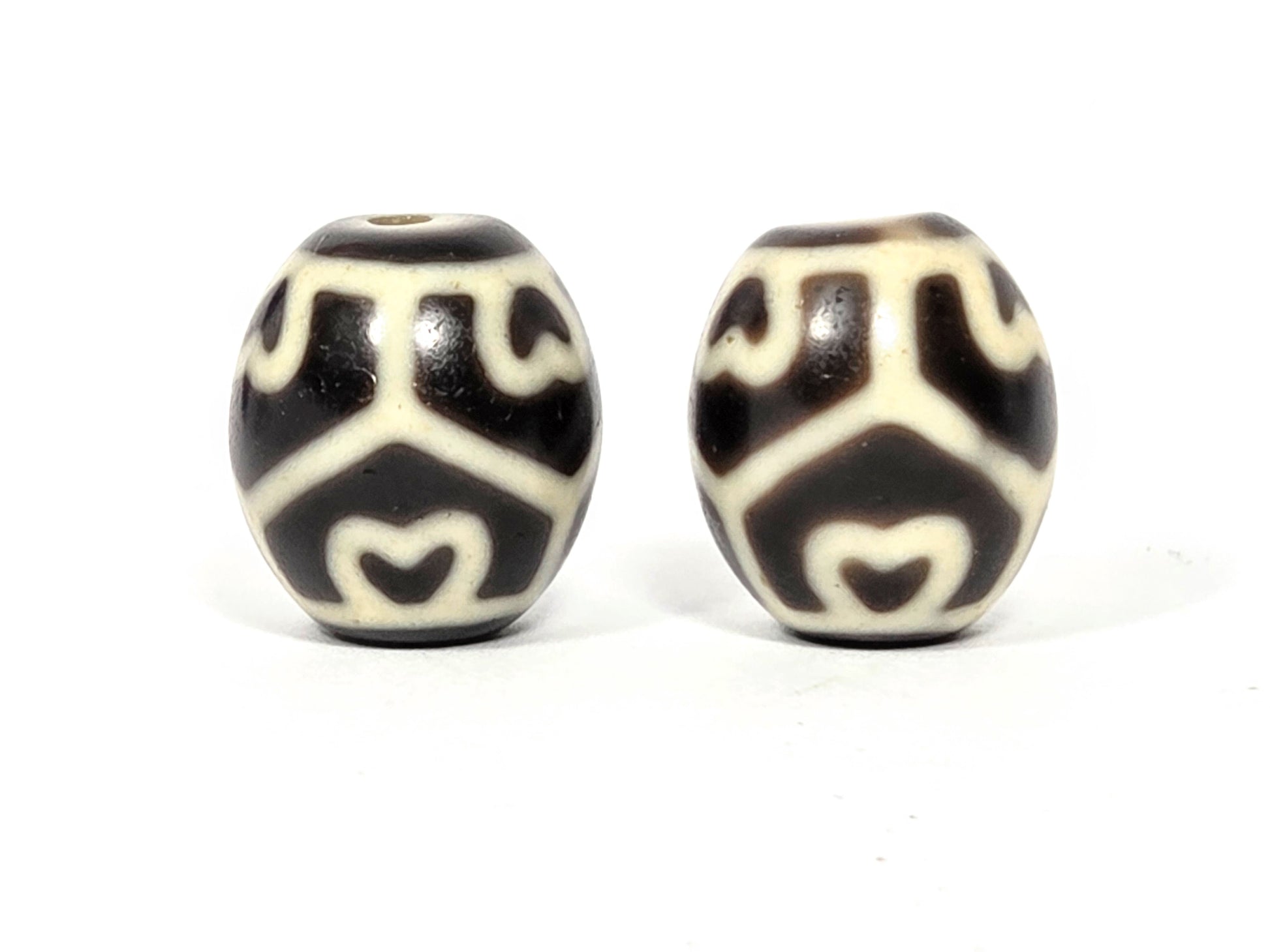 Pair of antique Tibetan Six Eye Lotus round Dzi beads, 17.7mm × 15.9mm and 18.0mm × 15.7mm — Side A showing Six Eye Lotus motif on deep brown and ivory natural agate — unretouched photo — Ancient Dzi Shop