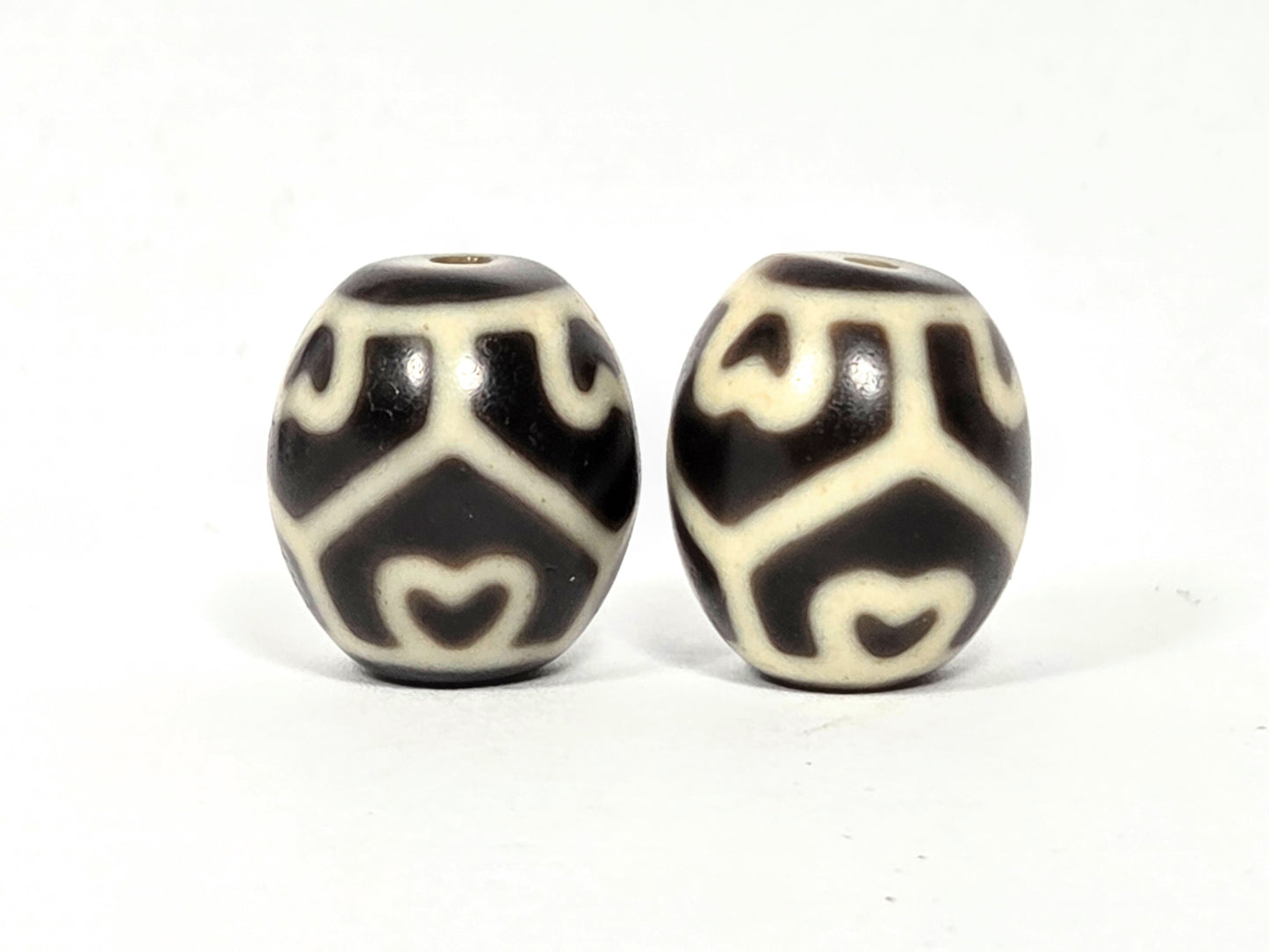 Pair of antique Tibetan Six Eye Lotus round Dzi beads — Side B showing lower lotus and eye pattern detail on natural agate — matched pair — unretouched photo — Ancient Dzi Shop