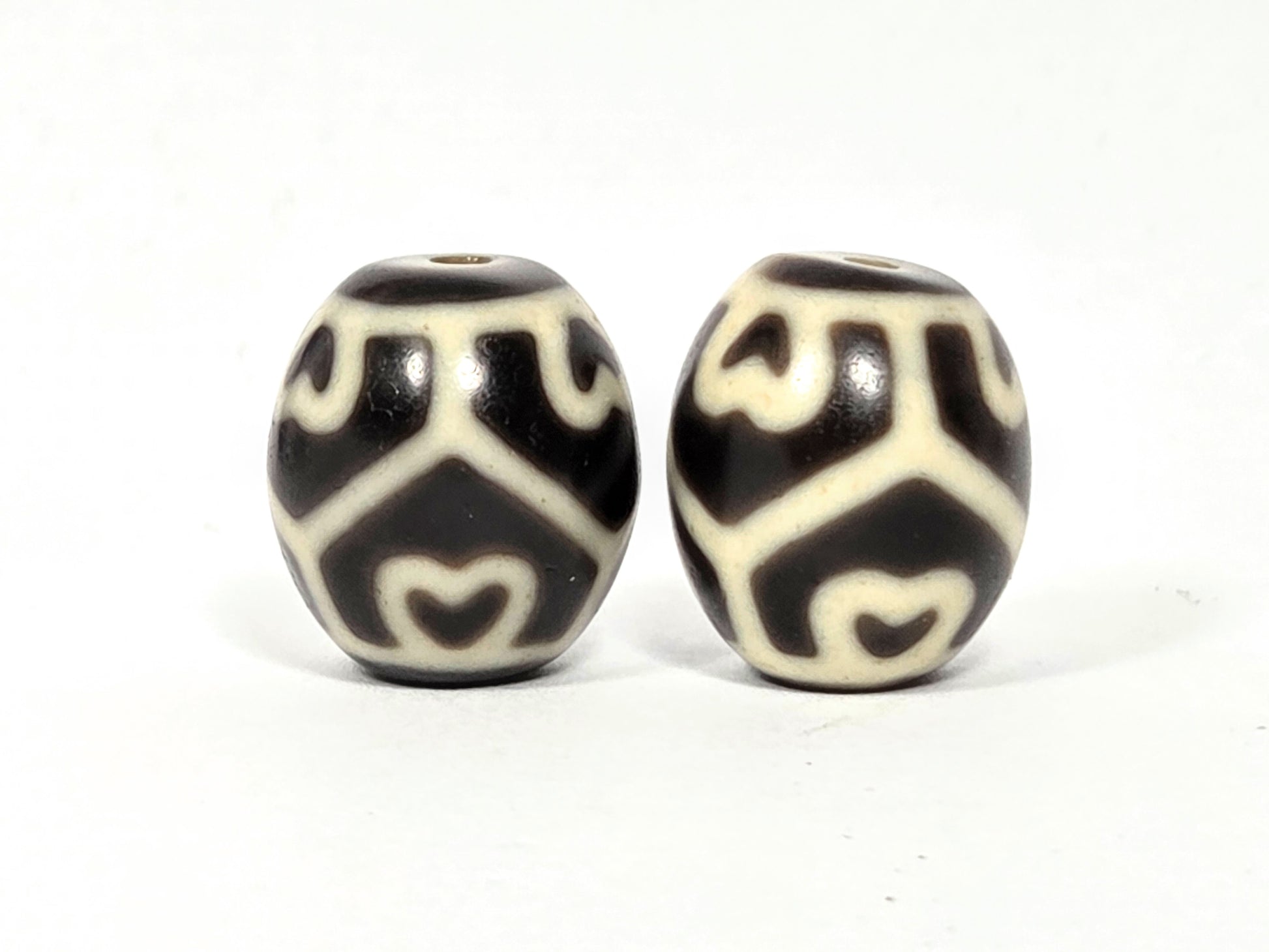 Pair of antique Tibetan Six Eye Lotus round Dzi beads — Side B showing lower lotus and eye pattern detail on natural agate — matched pair — unretouched photo — Ancient Dzi Shop