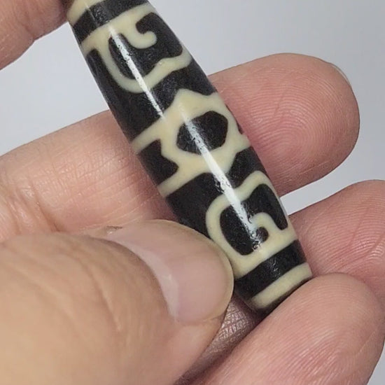 At-090626-GRDC2 antique Guru Rinpoche Dharma Cap dzi bead 49.8x13.2mm rotating 360 view pitch-black agate all faces unretouched