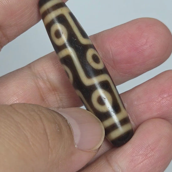 At-091626-9E antique Tibetan nine eye dzi bead 54.6x12.5mm dark brown agate rotating view all faces unretouched