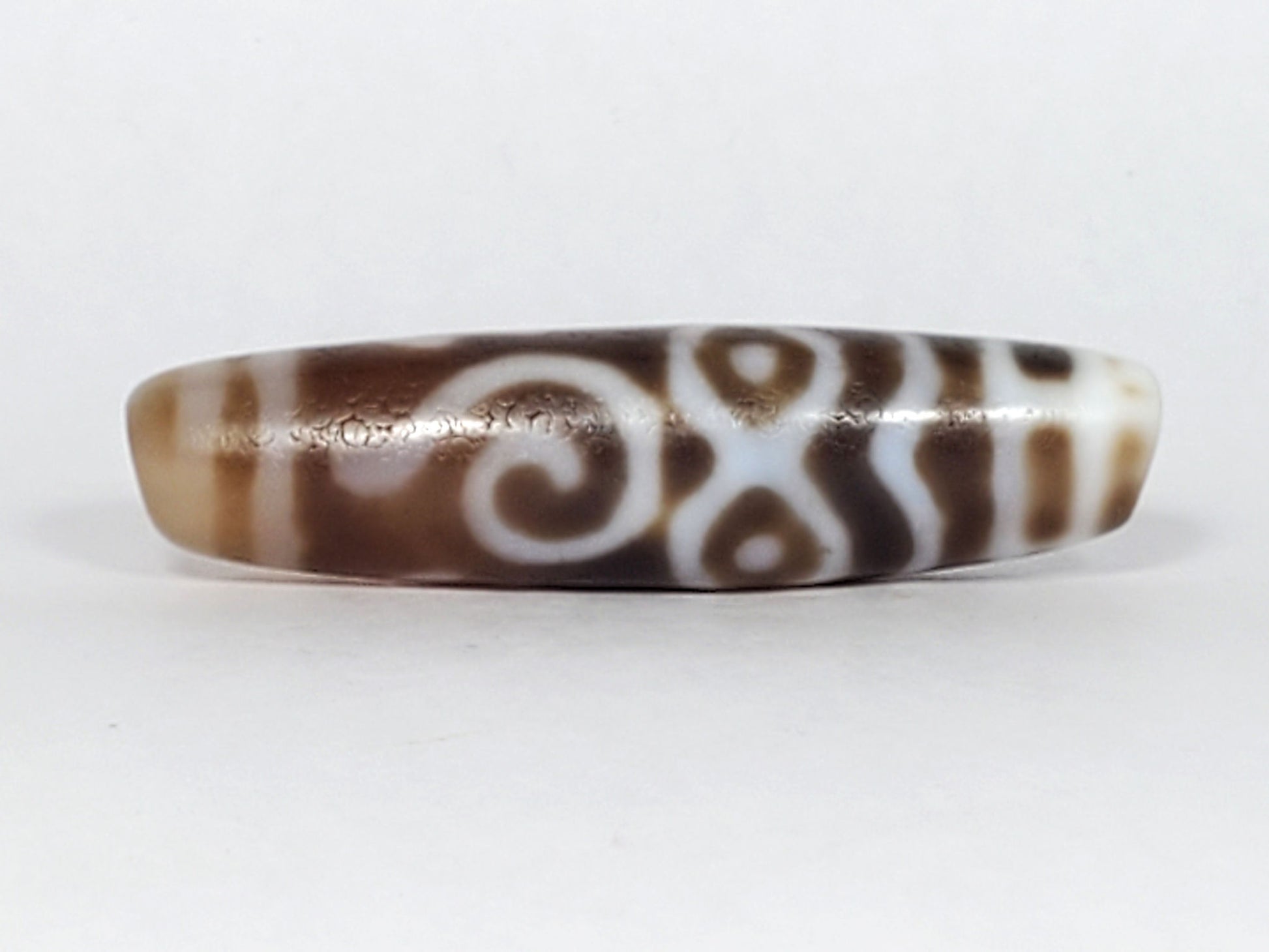 At-061926-PDEBS Face B, double-spiral scroll composition, warm brown chalcedony ground, unretouched