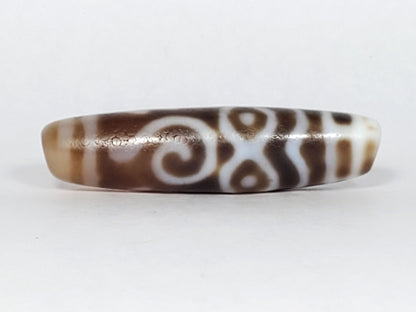 At-061926-PDEBS Face B, double-spiral scroll composition, warm brown chalcedony ground, unretouched