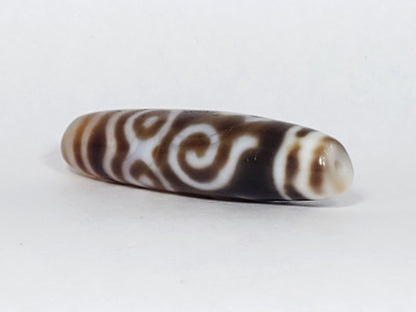 At-061926-PDEBS angled tip A, honey-tan end cap, scroll motif wrap, high-gloss surface, unretouched
