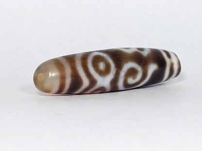 At-061926-PDEBS angled tip B, honey-tan cap, small drill hole, scroll detail visible, unretouched