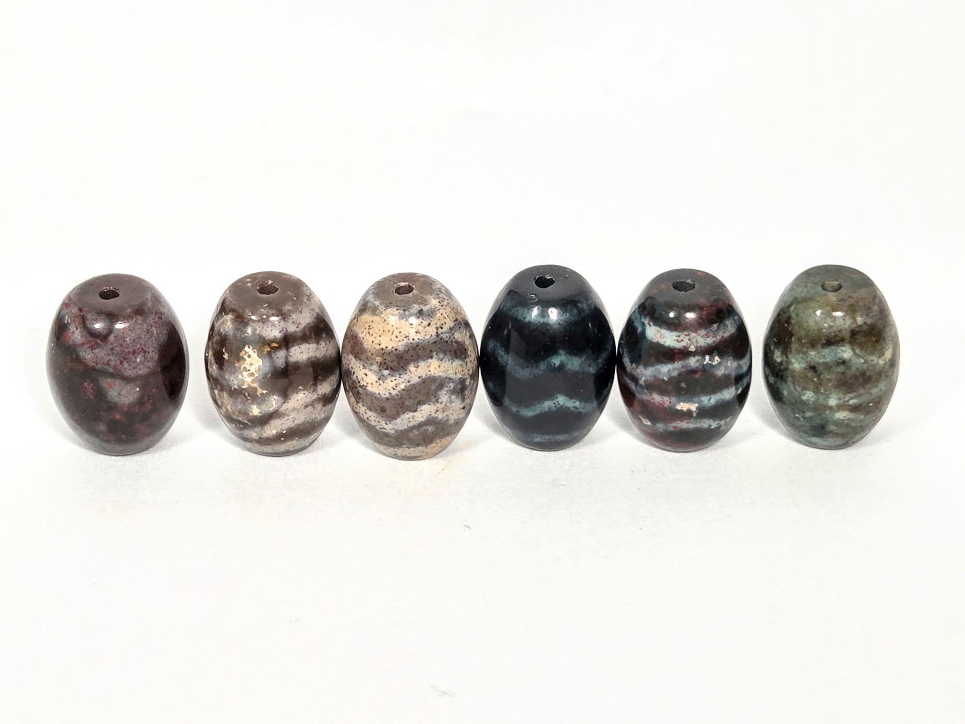 N-062626-6WDWBS clearance set six new wave dzi with bloodspots, front view, six distinct grounds, unretouched