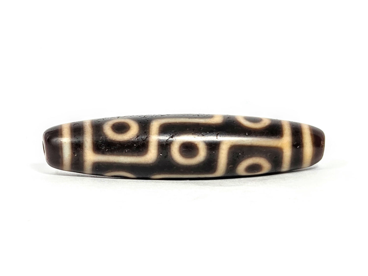 At-070626-9E antique nine eye dzi face B, deep dark brown ground, bold cream stepped eye network rotated, unretouched