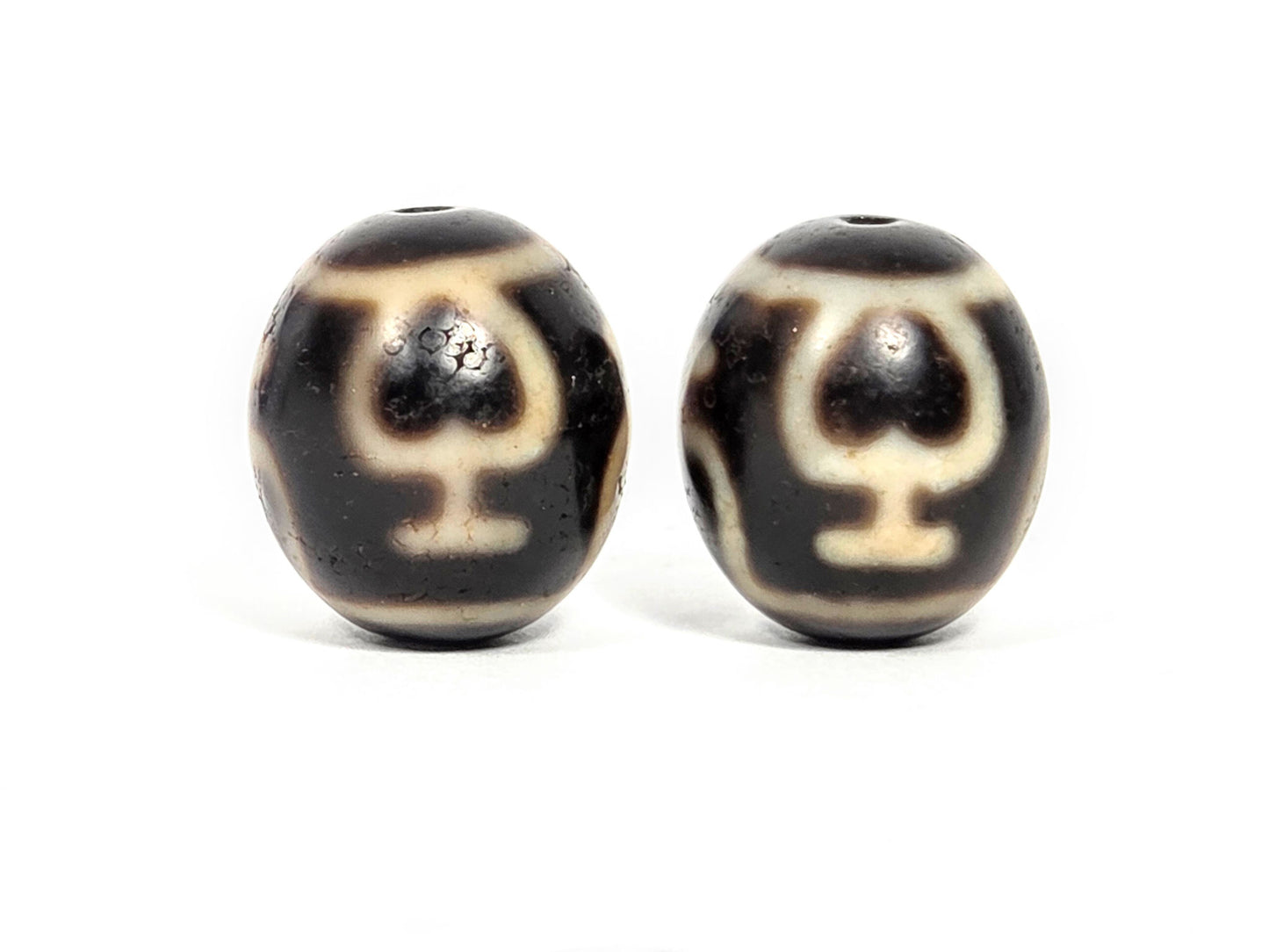 V-071426-TVV Treasure Vase pair face B alternate — chalice form, Bead B crisper lines, dark agate, unretouched.
