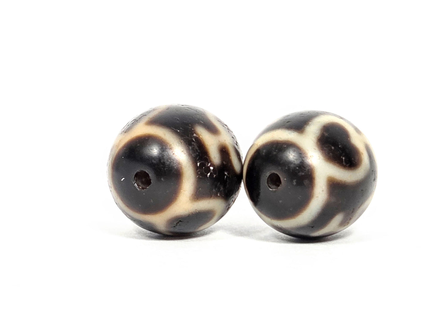 V-071426-TVV Treasure Vase pair end angle B — cream wrap, both drill openings visible, dark agate, unretouched.