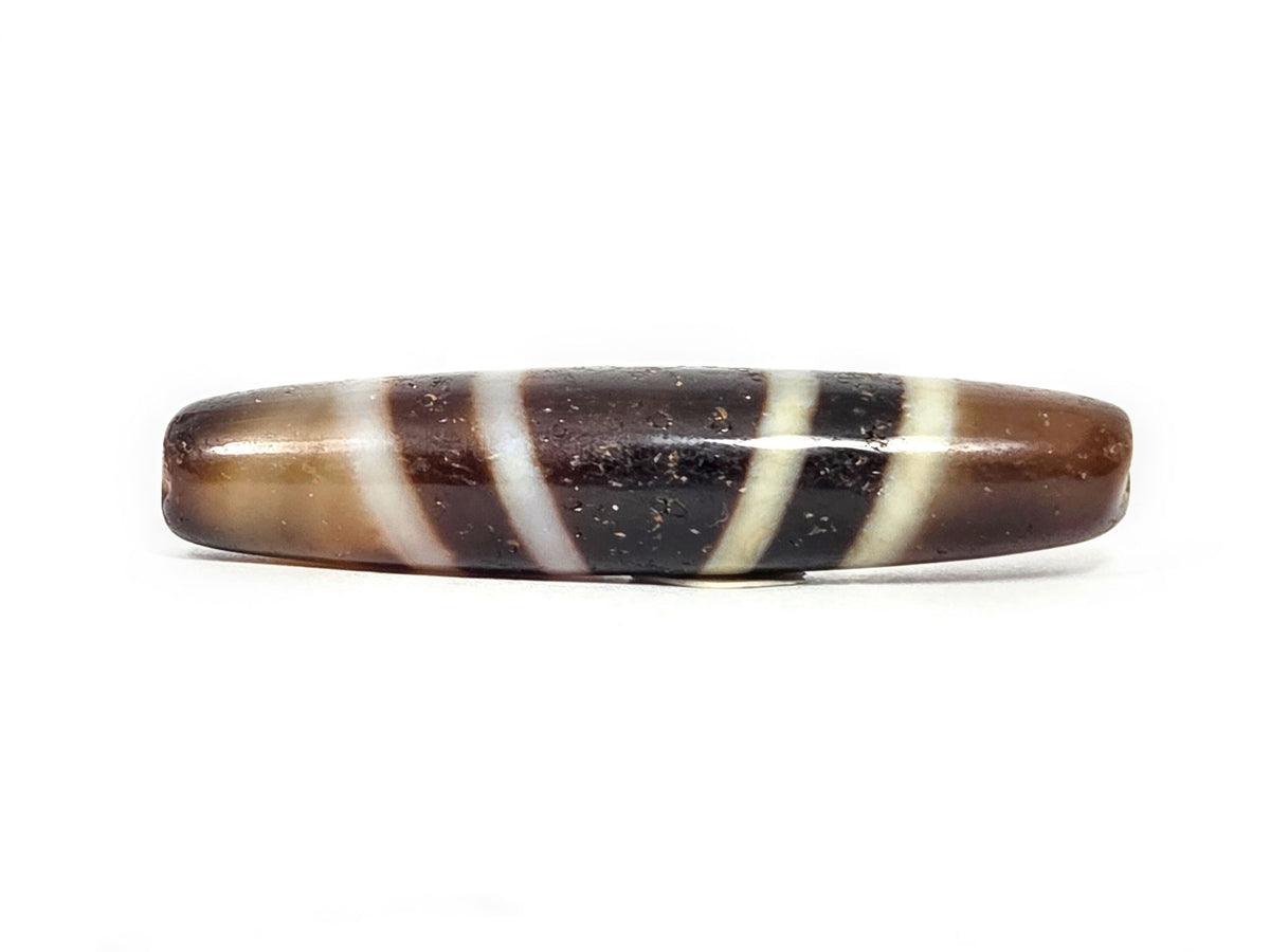 V-052222-7SChung, 57.7×12.6mm seven stripe Chung dzi, chocolate-brown ground, cream stripes, asymmetric taper, unretouched