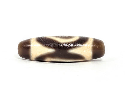V-071126-HE connector face, curved X hourglass cream pattern on dark brown ground, vintage Heaven Earth dzi, unretouched
