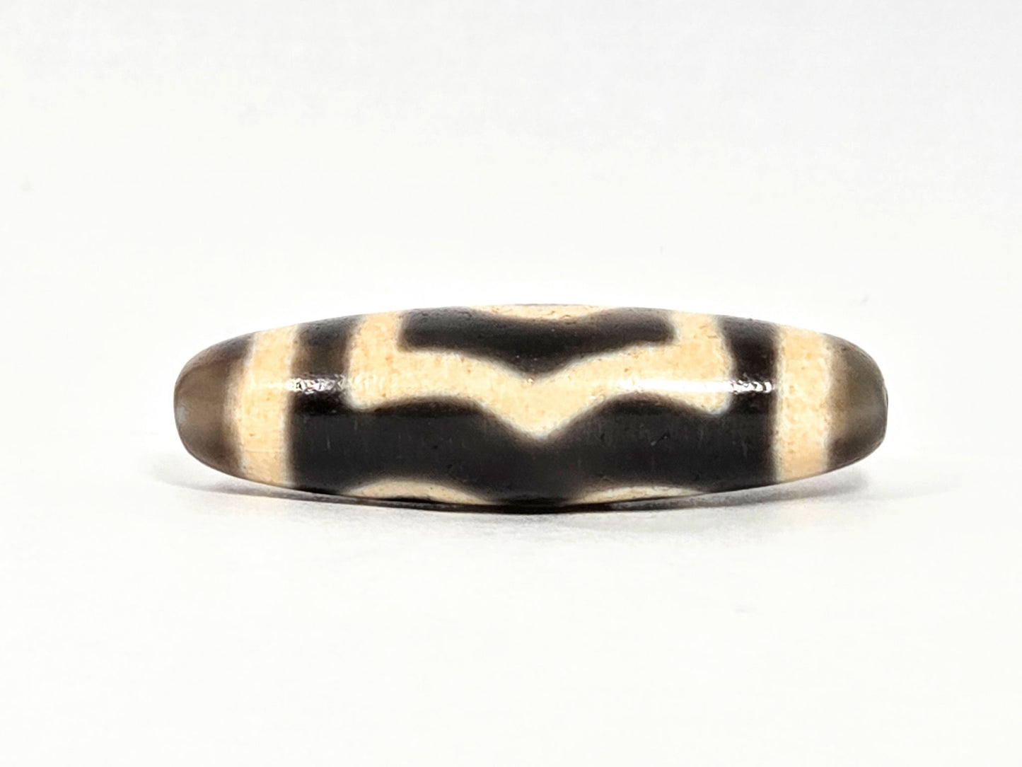 V-071126-3E wave-chevron connector face, cream W pattern on pitch-black field, vintage Taiwan dzi, unretouched