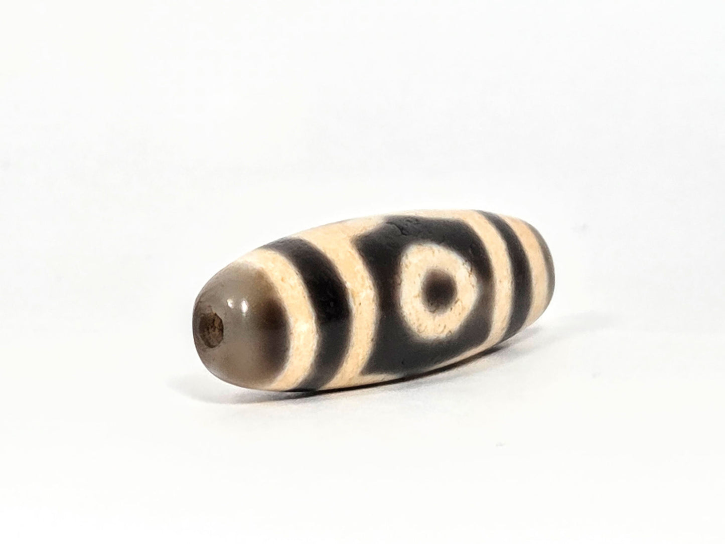 V-071126-3E opposite end view, warm grey end cap, second drill hole, cream and black banding on body, unretouched