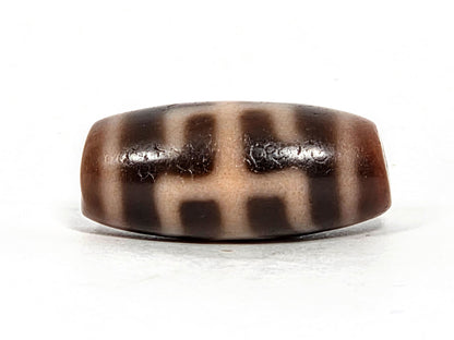 V-071426-BNF Benefactor Variant face B — structural grid reading, cream zones, warm dark brown ground, unretouched. 