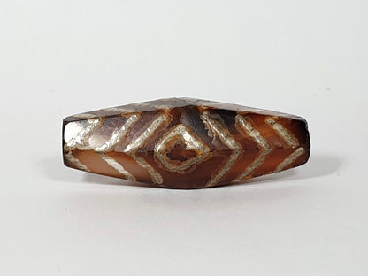 Ancient carnelian dzi bead with three eye and tiger stripe motif — rare hexagon shape in natural Himalayan carnelian agate